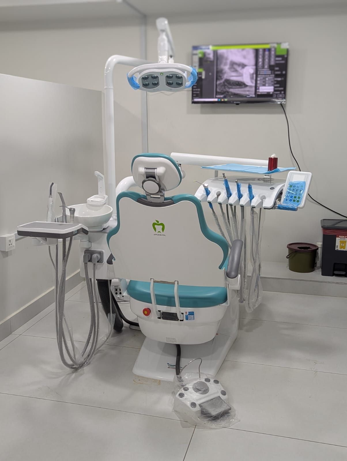 Dental operatory with chair, overhead light and imaging screen